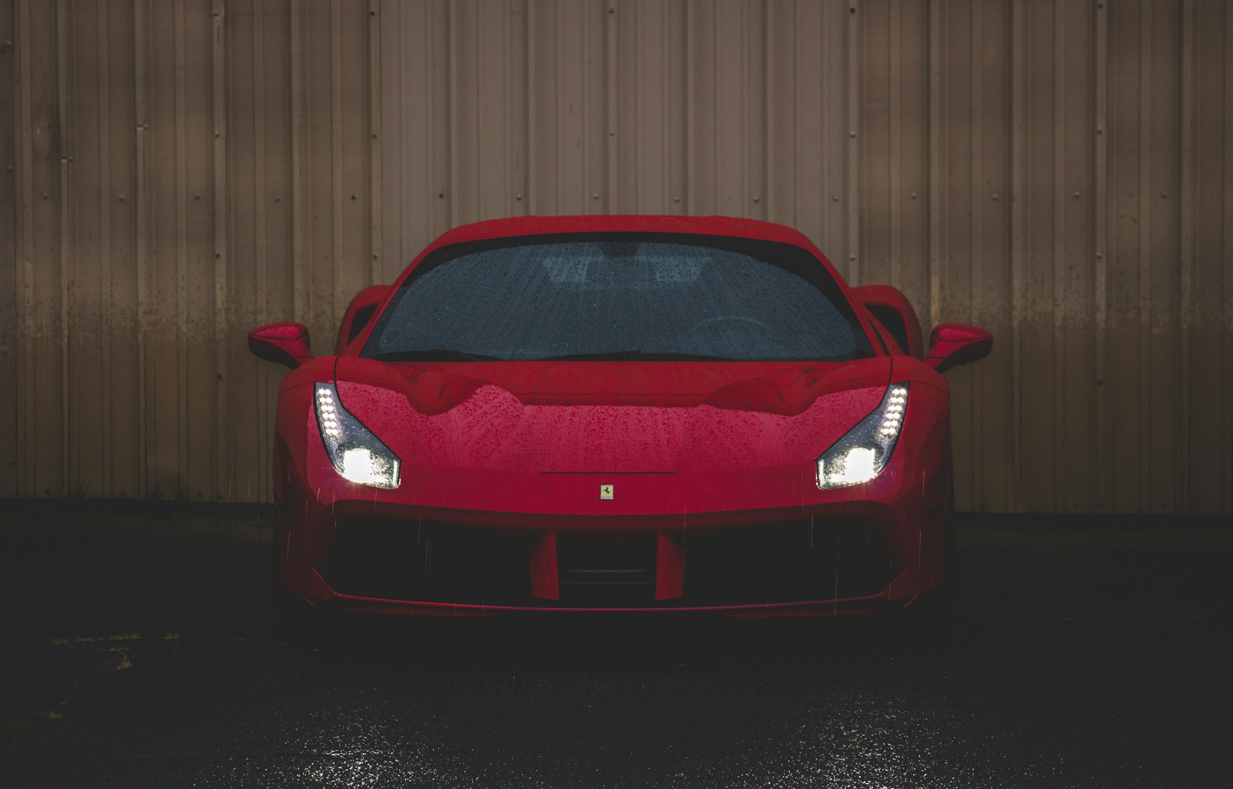 Red Ferrari sports car with rain and gloss finish