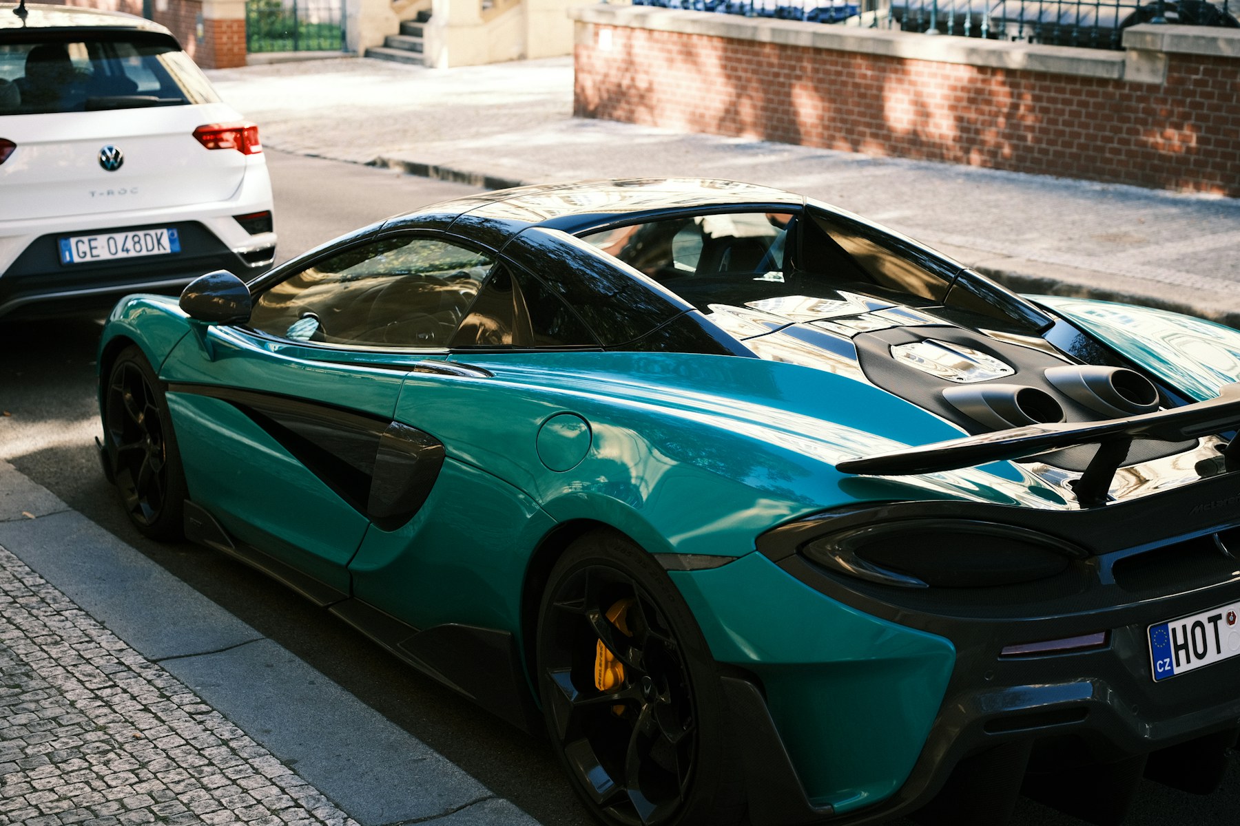 Teal McLaren sports car with gloss paint and carbon details